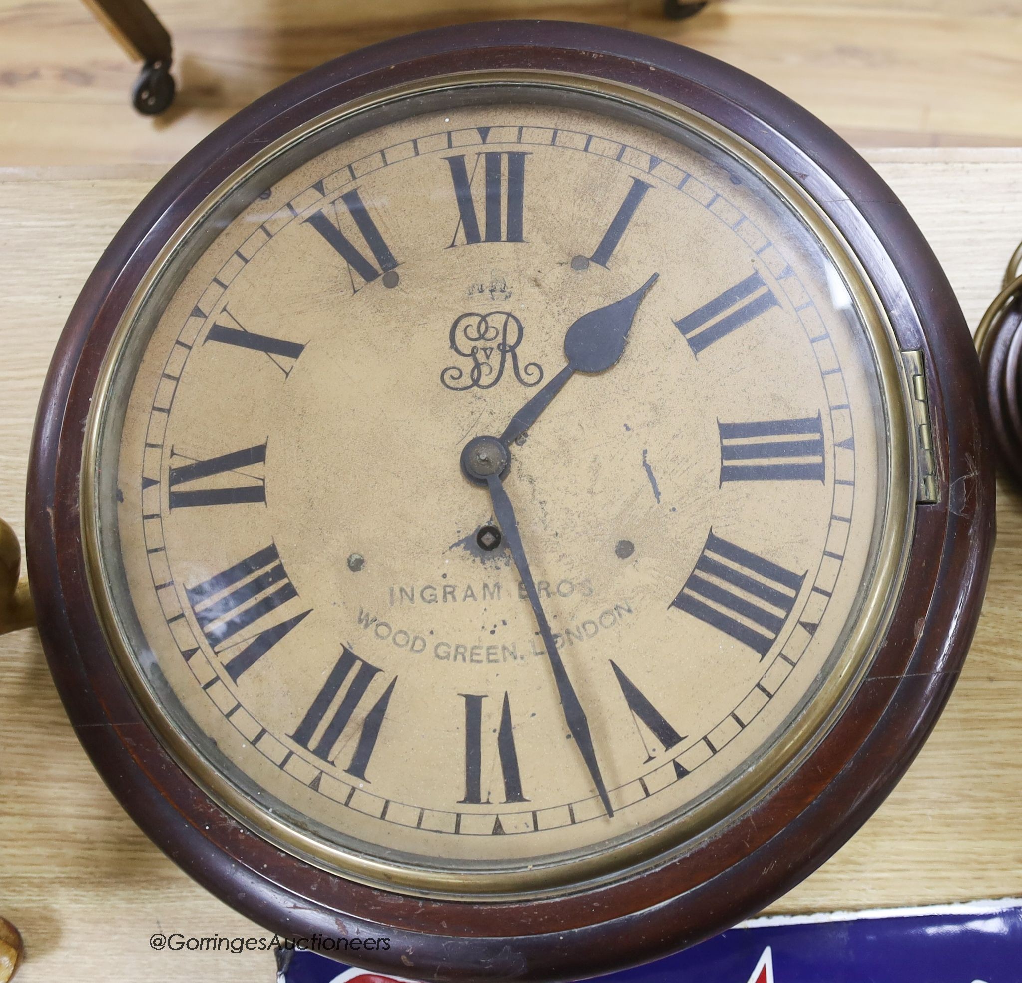 An early 20th century mahogany circular wall clock, with key and pendulum, diameter 39cm